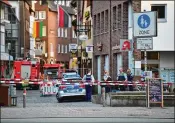  ?? ALEXANDER KOERNER / GETTY IMAGES ?? Police stand at a street blocking access to the site where a van was driven into a crowd outside a pub Saturday in Muenster, Germany. Police confirmed the driver committed suicide after the incident.