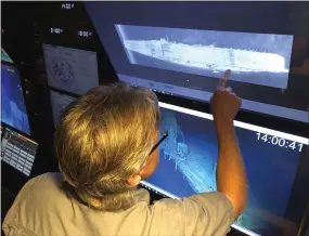  ?? CALEB JONES — ASSOCIATED PRESS ?? Rob Kraft, Vulcan Inc.’s director of subsea operations aboard the Petrel, looks at images of the sunken Japanese aircraft carrier Kaga on Oct. 16off Midway Atoll in the Northweste­rn Hawaiian Islands.