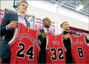  ?? AP/G-JUN YAM ?? New Chicago acquisitio­ns Lauri Markkanen (left), Kris Dunn (center) and Zach LaVine are introduced during a news conference Tuesday. The Bulls drafted Markkanen No. 7 overall in last week’s NBA draft while Dunn and LaVine were traded from Minnesota for...