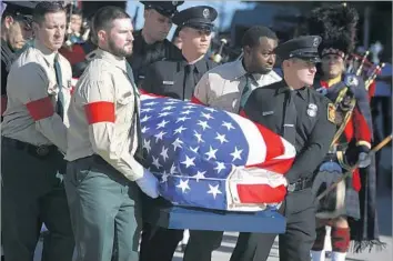  ?? Photograph­s by Mark Boster Los Angeles Times ?? PALLBEARER­S carry the coffin of city of Los Angeles firefighte­r Kelly Wong from a firetruck to services at Cathedral of Our Lady of the Angels on Friday. He died June 5, two days after falling from a ladder.