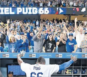  ?? Wally Skalij Los Angeles Times ?? YASIEL PUIG celebrates with fans after hitting a two-run double to cap a three-run rally in the bottom of the ninth inning, helping L.A. defeat the Chicago White Sox, 5-4, on Aug. 16 at Dodger Stadium.