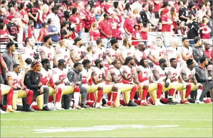  ?? NORM HALL/GETTY IMAGES/AFP ?? Members of the San Francisco 49ers kneel for the US national anthem before their game against the Arizona Cardinals at the University of Phoenix Stadium on October 1 in Glendale, Arizona.