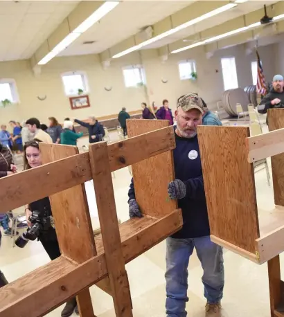  ?? Herald staFF File ?? BALLOT BRIGADE: Lowell DPW workers prepare the polls at the Senior Center a day before the election in Lowell in November 2018. Even more preparatio­ns will need to be made this year due to coronaviru­s concerns, but officials say they are taking all the necessary precaution­s.