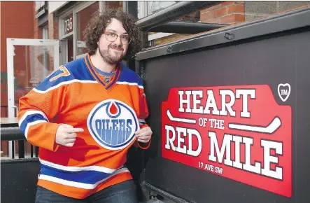  ?? JIM WELLS ?? Graham Mosimann, local radio DJ and a huge Edmonton Oilers fan, is on the patio of the Royal Brasserie in his jersey on what used to be the world famous Red Mile in Calgary Tuesday. The Royal Brasserie is formerly Melrose Cafe which first gained fame...