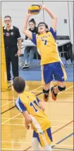  ?? JASON SIMMONDS/JOURNAL PIONEER ?? Emmett Gaudette of the Westisle Wolverines sets the ball while teammate Chandler Buote, 11, follows the play. The Wolverines visited the Three Oaks Axemen for a semifinal match in the P.E.I. School Athletic Associatio­n Senior AAA Boys Volleyball League. Three Oaks won the contest 3-1.