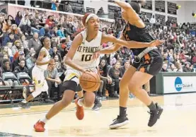 ?? KENNETH K. LAM/BALTIMORE SUN ?? St. Frances forward Angel Reese, driving against McDonogh's Jessica Booth last season, averaged 17.6 points and 12.1 rebounds per game for the IAAM A Conference champion.