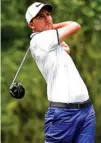  ?? Associated Press ?? n Russell Henley hits his tee shot on the 15th hole Sunday during the final round of the Houston Open in Houston. Henley won the tournament over Sung Kang.