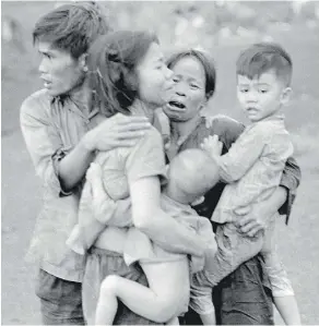  ?? HORST FAAS/THE ASSOCIATED PRESS/PBS ?? Civilians huddle together after an attack by South Vietnamese forces in Dong Xoai in June 1965. Given that the Vietnam conflict was the first TV war, it is fitting that the definitive statement should be made in that medium, Jack Todd writes.