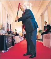 ??  ?? US President Donald Trump takes a swing with a bat from Texas Timber before speaking at a Spirit of America showcase event on small businesses at the White House, in Washington, DC.