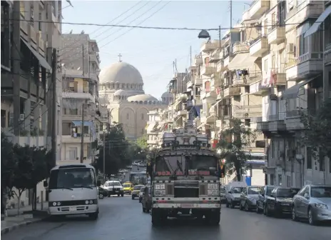  ??  ?? Left, an image of Aleppo taken in 2010 by Alex Anyan; below, a 2007 picture of the Happy Land amusement park in Damascus