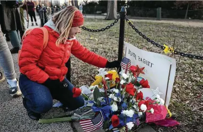  ?? Joe Raedle / Getty Images ?? Melody Black, from Minnesota, becomes emotional as she visits a memorial that was set up near the U.S. Capitol for Ashli Babbitt, who was killed in the building after a pro-trump mob broke in on Wednesday.