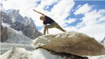  ??  ?? Below Kate holding a yoga pose at Link Sar in Pakistan in October 2019