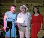  ?? (NWA Democrat-Gazette/Marc Hayot) ?? Marty Harrison (center) receives the Volunteer of the Year award from Bernadette Keck (left) on May 20 as Stacy Morris looks on in Siloam Springs.