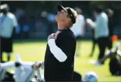  ?? AP PHOTO BY ERIC RISBERG ?? Oakland Raiders head coach Jon Gruden smiles watching his team stretch during NFL football practice in Napa, Calif., Friday, July 27.