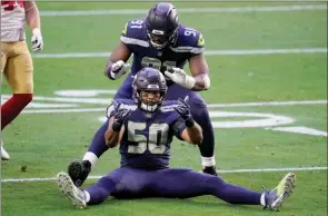  ?? The Associated Press ?? Seattle Seahawks linebacker K.J. Wright and defensive end L.J. Collier celebrate a defensive stop against the San Francisco 49ers on Sunday in Glendale, Ariz.