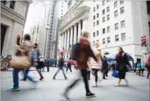  ??  ?? Pedestrian­s pass in front of the New York Stock Exchange. MICHAEL NAGLE/BLOOMBERG