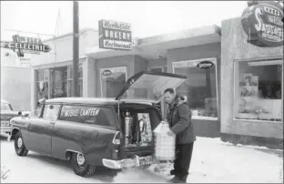  ?? Galt Archives photo 1975250815­2LH ?? A worker fills a mobile canteen vehicle in front of Northside Bakery and Restaurant at 428 13 St. N. in 1958.