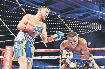  ??  ?? Vasiliy Lomachenko (left) punches Guillermo Rigondeaux during their Junior Lightweigh­t bout at Madison Square Garden in New York City. — AFP photo