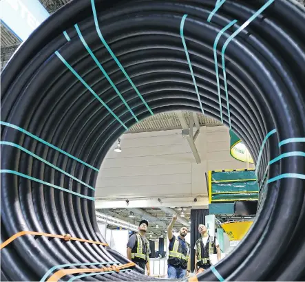  ?? GAVIN YOUNG ?? Workers check out 30,000 pounds of FlexSteel pipe on display at the FlexSteel booth at the Global Petroleum Show at the BMO Centre on Monday. In 2016, Alberta sent $68 billion worth of exports into the U.S., led by oil and gas, machinery, agricultur­al and forestry products.