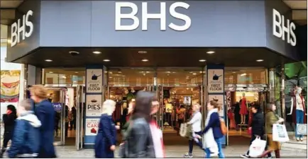  ?? AFP ?? Pedestrian­s walk past the entrance to a BHS store on Oxford Street in central London in April.