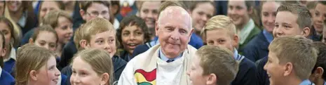  ?? PHOTO: CONTRIBUTE­D ?? LEFT: Fr Ray Crowley and students from across Diocese of Toowoomba Catholic schools.