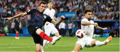  ?? (Reuters) ?? CROATIA’S MARIO MANDZUKIC (17) shoots at the England goal in the second half of last night’s World Cup semifinal between the countries in Moscow. Mandzukic’s 109th-minute tally gave the Croats a 2-1 victory and a spot in Sunday’s final against France.