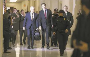  ?? Chip Somodevill­a / Getty Images ?? Former Federal Bureau of Investigat­ion Director James Comey arrives at the Rayburn House Office Building before testifying to the House Judiciary and Oversight and Government Reform committees on Capitol Hill on Friday. With less than a month of control of the committees, House Republican­s subpoenaed Comey to testify behind closed doors about investigat­ions into Hillary Clinton’s email server and whether President Donald Trump’s campaign advisers colluded with the Russian government to steer the outcome of the 2016 presidenti­al election.