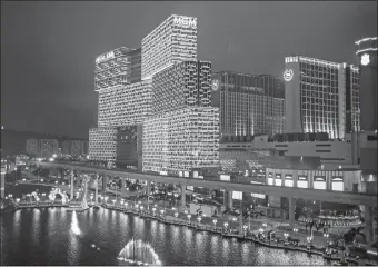  ?? BILLY H.C. KWOK/BLOOMBERG ?? The MGM Grand Macau casino at night in Macao, China. The world’s biggest gambling hub seems to be exploring digital currency as a way to combat money laundering and tax evasion.