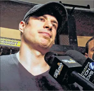  ?? CP PHOTO ?? Pittsburgh Penguins’ Sidney Crosby talks with media while cleaning out his locker at the NHL team’s training facility in Cranberry, Pa., on May 9.