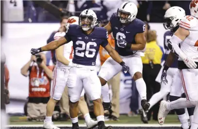  ??  ?? Penn State running back Saquon Barkley ( 26) celebrates after catching an 18- yard touchdown pass in the fourth quarter. | AP