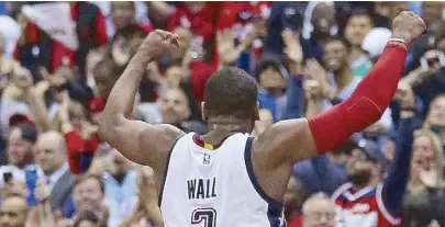  ?? AFP ?? John Wall of the Washington Wizards joins the crowd in a celebratio­n after hitting the game-winning three-point basket over the Boston Celtics in Game Six of the NBA Eastern Conference semifinal at Verizon Center in Washington, DC.