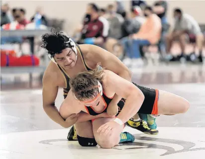  ?? MIKE MANTUCCA/DAILY SOUTHTOWN ?? Lockport’s Jon Kratz, top, takes control against Lincoln-Way West’s Evan Dluzak in the 220-pound match during a dual meet in Lockport on Thursday.