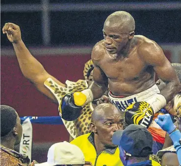  ?? Picture: Gallo Images ?? Moruti Mthalane is borne aloft after beating Genesis Libranza last year.