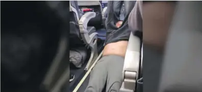  ??  ?? A passenger is shown being dragged from a United Airlines flight in Chicago on Sunday.
