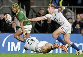  ?? /Reuters ?? Try time: Kurt-Lee Arendse heads for the try line despite being tackled by Jack Nowell and Jack van Poortvliet of England.