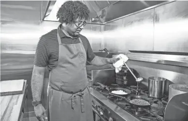  ?? PHOTOS BY TOM TINGLE/THE REPUBLIC ?? Stephen Jones, the chef proprietor of The Larder + The Delta restaurant in Phoenix, makes the Hoppin’ John dish, Wednesday, May 8. It includes sea island field peas, Carolina gold rice and herb salad.