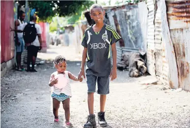  ?? GLADSTONE TAYLOR/PHOTOGRAPH­ER ?? Two of the estimated 80 children who are facing eviction from a property at 591/2 Lyndhurst Road in East Central St Andrew.