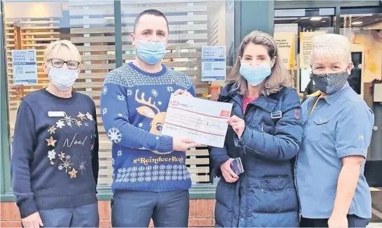  ?? ?? On a roll Mcdonald’s staff present their £100 cheque to St Augustine’s toy donation