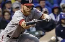  ?? NAM Y. HUH/THE ASSOCIATED PRESS ?? Washington’s Stephen Strasburg struck out 12 in seven shutout innings, and added a sacrifice bunt, in the Nationals’ 5-0 win over the Cubs.