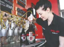  ?? DON HEALY FILES ?? Chelsea Humble fills a growler at Rebellion Brewing, part of the influx of craft breweries into Regina over the past decade.