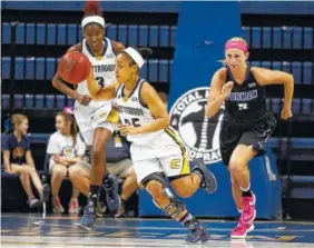  ?? STAFF FILE PHOTO BY DOUG STRICKLAND ?? UTC point guard Chelsey Shumpert, center, breaks away from Furman’s Allison Beasley, right, with a stolen ball during the Mocs’ Feb. 23 win at McKenzie Arena. They will face Louisville in the NCAA tournament Saturday.