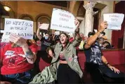  ?? RINGO H.W. CHIU / AP, FILE ?? People hold signs and shout slogans as they protest before the cancellati­on of the Los Angeles City Council meeting on Oct. 12 in Los Angeles.