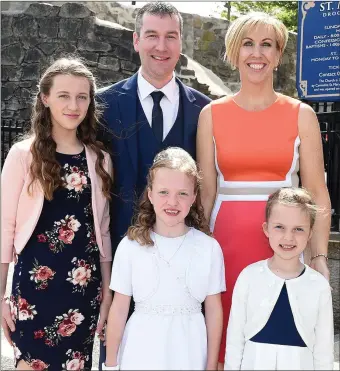  ??  ?? Laura faulkner from St. Mary’s school who received First Holy Communion in St. Mary’s church pictured with parents Robbie and Judith and sisters Anna and Niamh.