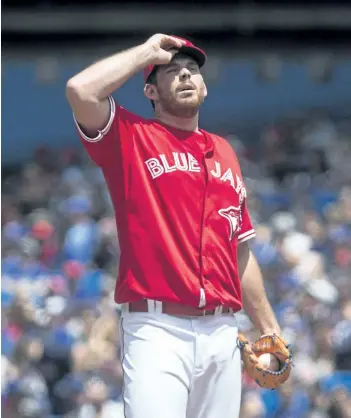  ?? CHRIS YOUNG/THE CANADIAN PRESS ?? Toronto Blue Jays’ starting pitcher Joe Biagini reacts after walking Boston Red Sox Mitch Moreland during first inning Major League baseball action in Toronto, on Sunday.