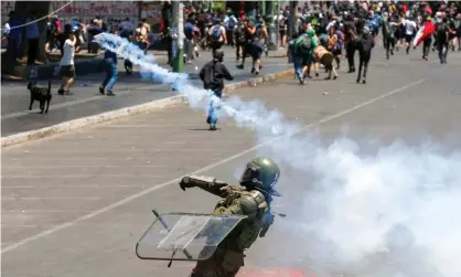  ??  ?? A member of the security forces throws a teargas canister during a protest in Valparaíso on Tuesday. Photograph: Rodrigo Garrido/ Reuters