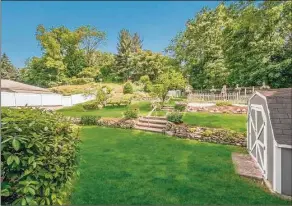  ?? Contribute­d by Douglas Elliman Real Estate ?? The three-bedroom home is sited on a 0.42-acre lot, with a deck, storage shed, lush lawn and tiered perennial gardens.