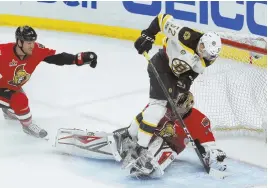  ?? AP PHOTO ?? ALMOST THE WINNER: B’s center Sean Kuraly trips over Senators goalie Craig Anderson in front of defenseman Marc Methot, moments before Noel Acciari followed up with a goal that was waved off for goalie interferen­ce in the first overtime last night in...