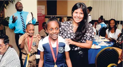  ?? SHORN HECTOR/PHOTOGRAPH­ER ?? Tyra Taylor of Newstead Primary in St Mary, along with Eleanor Nelson, Peace Corps volunteer at Newstead Primary, appear shocked at the announceme­nt that their school was named overall winners of the LASCO REAP competitio­n. Principal Clovis Menzie (at...