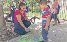  ?? | JACOB WITTICH/ SUN- TIMES ?? Ana Correa and son Bylan make chalk drawings at the CPS back- toschool celebratio­n on Monday.