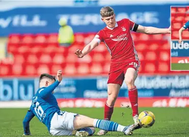  ??  ?? Saints’ Glenn Middleton gets in a vital tackle against Aberdeen’s Jack Mackenzie